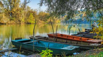Autumn mood along River with abandoned fishing boats